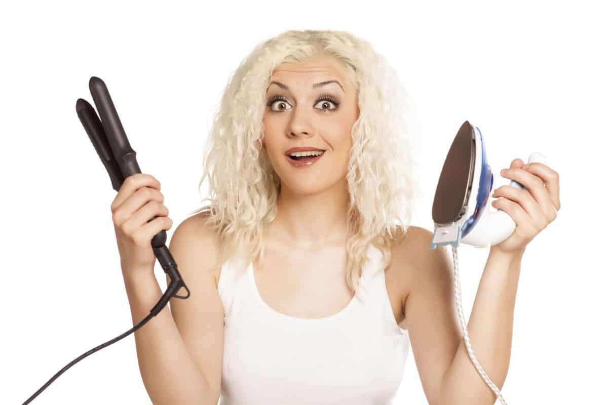 woman holding flat iron and clothes iron_resized