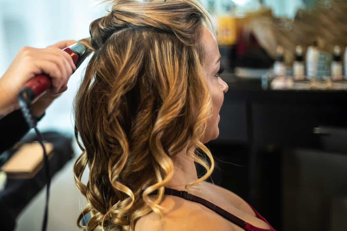 woman getting hair curled