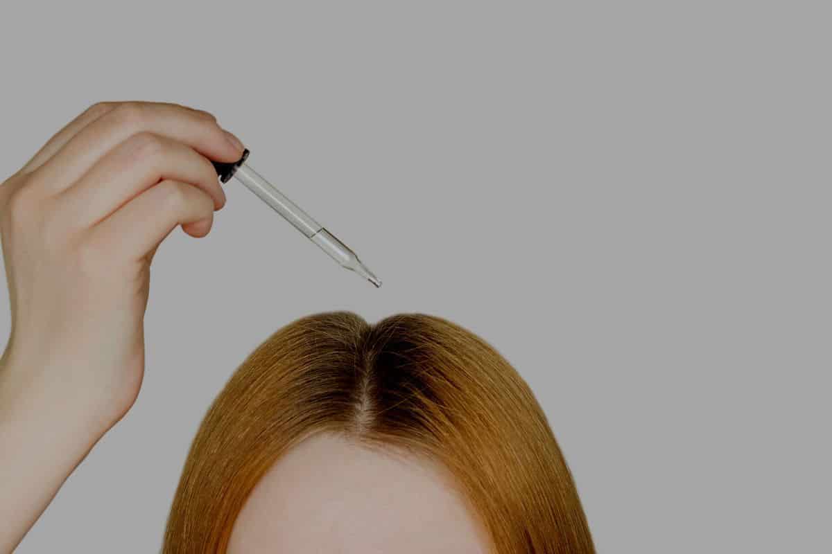 woman using dropper on hair