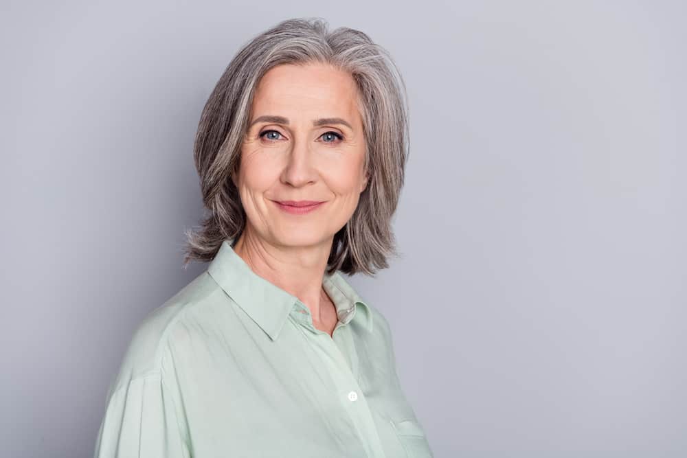 mature woman with gray hair and subtle makeup
