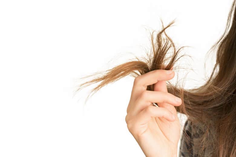 woman holding damaged hair ends